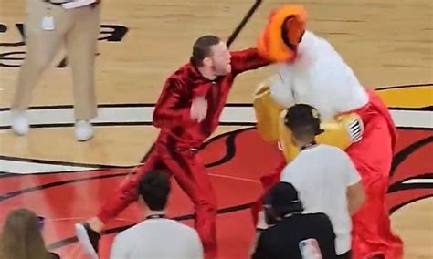 Mcgregor throwing a left hook at the mascot